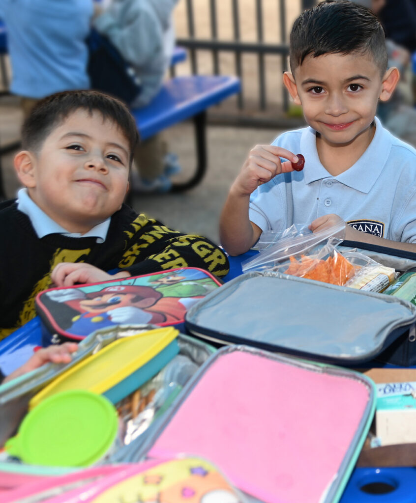 Two elementary grade students sitting together at lunch.